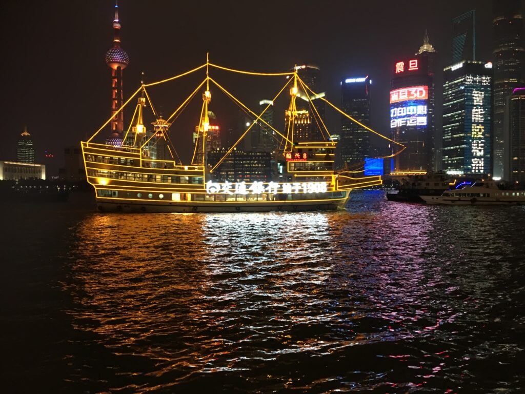 The colours of Shanghai Harbour light up the darkness of the night